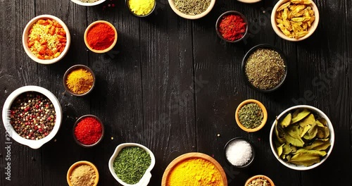 Wallpaper Mural From above view of many bowls full of spices of different type and color on black wooden background Torontodigital.ca