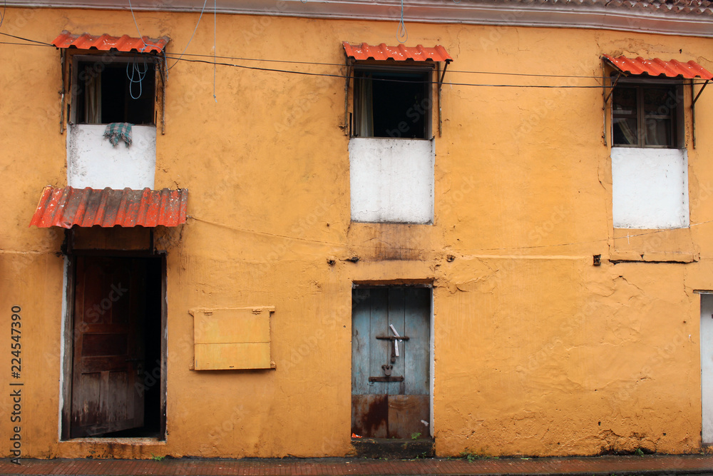 Translation: the yellow vintage and colorful windows and doors in Goa City.