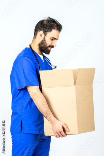 doctor smiling and holding a box . on white Studio background © fusssergei