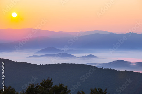 early morning scene, sunset among a misty mountain valley