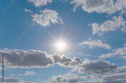 sparkle sun on the blue cloudy sky  nature background