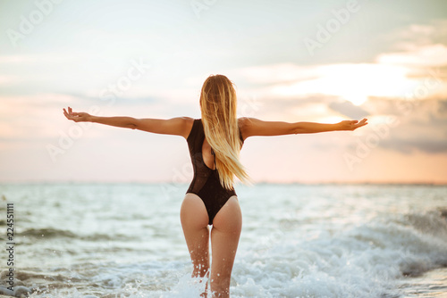 Outdoor lifestyle portrait of beautiful girl in black swimsuit © Margo Basarab