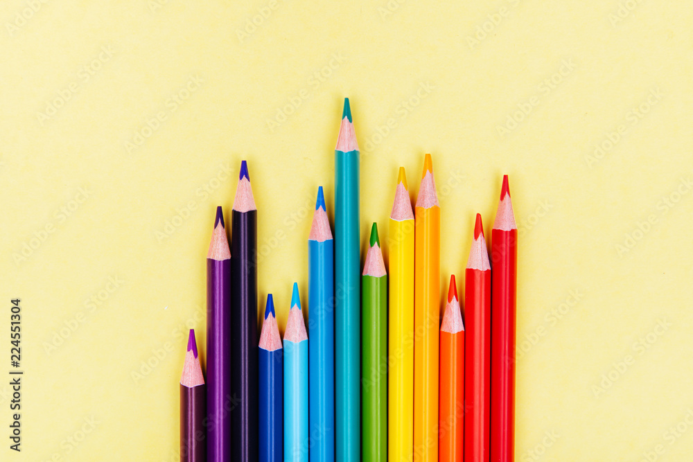 Color pencils in a row on yellow background. Color pencils in a row on yellow background.