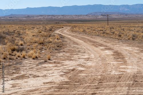 Obraz na plátne Lonely desert dirt and gravel road in rural New Mexico in the Four Corners area