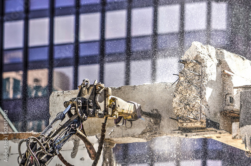 Pneumatic jackhammer in the process of seperating a concrete beam at a demolition site in Rotterdam photo