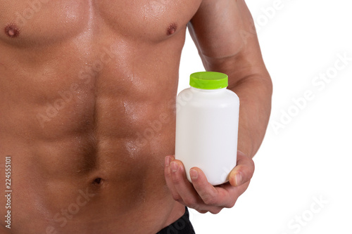Sports supplements and attractive athletic man. White background.