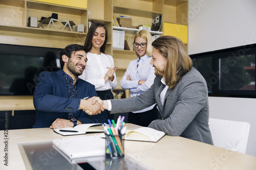Businessmen handshaking aft...