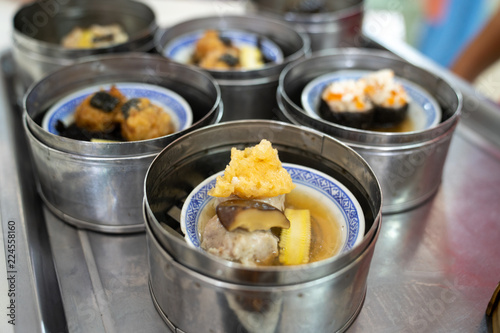 Dim sum on a food shelves, various Chinese steamed dumpling in bamboo basket steamer in Chinese restaurants.Yumcha or Dimsum photo