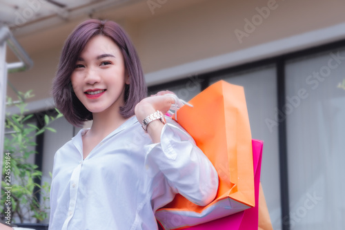 happy woman smile and holding shpping bags shopping on the day