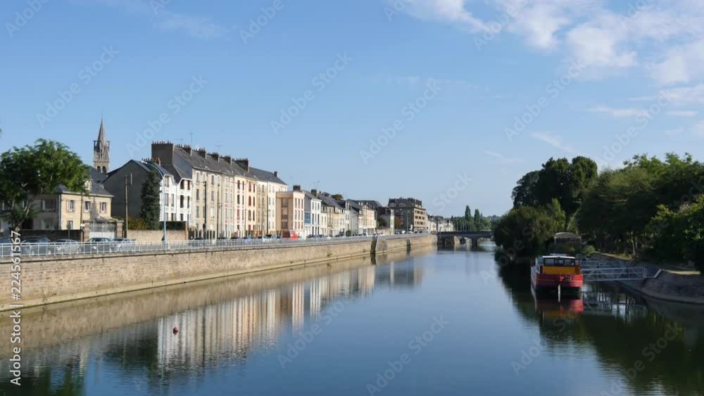 Buildings are reflected on the Sarthe River in the city of Le Mans in western France. Le Mans is an important city in the Pays de la Loire region. Filmed during the summer, sky with some clouds. Buildings are reflected on the Sarthe River in the city of Le Mans in western France. Le Mans is an important city in the Pays de la Loire region. Filmed during the summer, sky with some clouds.