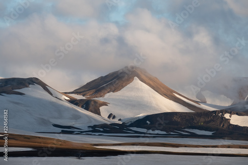 Snowed summer hiking trails near the Hrafntinnusker (Obsidian Reef) Campsite in the Fjallabak Nature Reserve along the famous Laugavegur hiking trail in the Highlands of Iceland