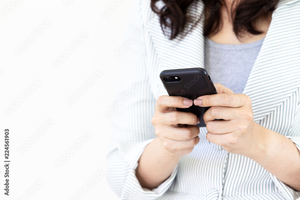 Asian business women in the white suit are using a smartphone. Asian business women in the white suit are using a smartphone.