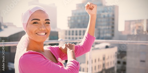 Strong woman in city with breast cancer awareness photo