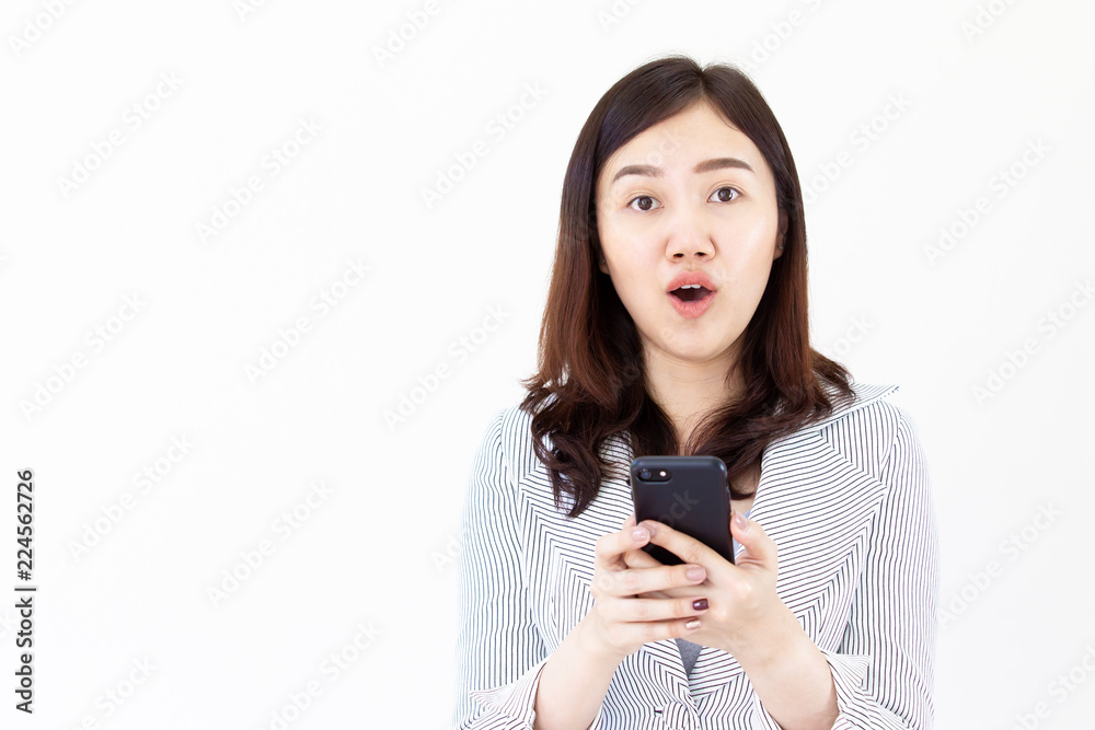 Asian women in white suit looking at her smartphone interestingly Asian women in white suit looking at her smartphone interestingly