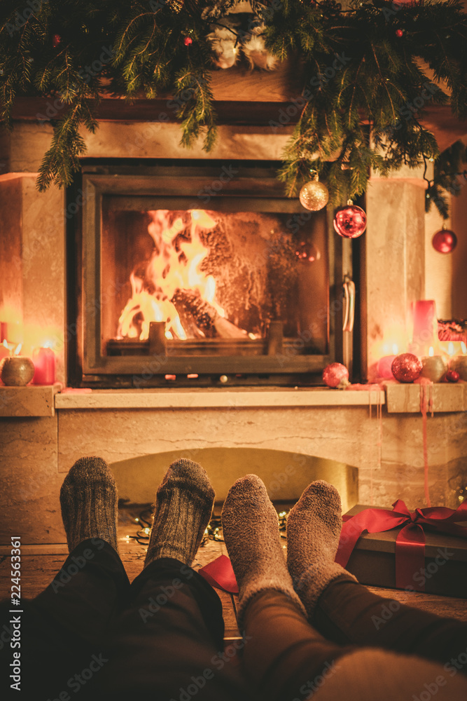 Family in socks near fireplace