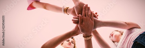 Billede på lærred Composite image of woman joining hands for breast cancer