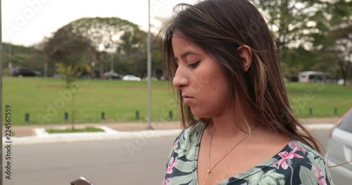 Girl holding cellphone with one hand typing on smartphone3 photo