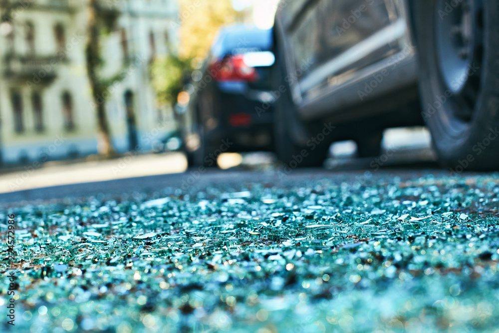 Sharp shards of car glass on the asphalt