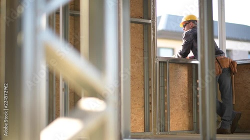 Wallpaper Mural Construction Worker in His 30s Wearing Hard Hat Relaxing in the House Window. Torontodigital.ca