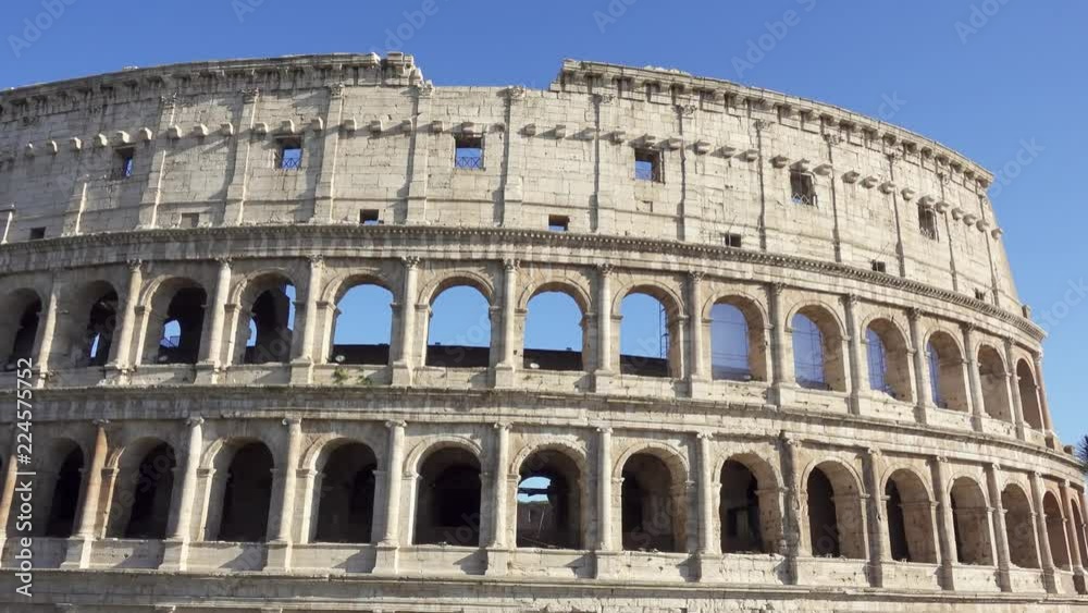 Famous Italian attraction Colosseum in Rome. Veiw on ancient Flavius amphitheater Coliseum in capital of Italy. Camera moving from right to left Famous Italian attraction Colosseum in Rome. Veiw on ancient Flavius amphitheater Coliseum in capital of Italy. Camera moving from right to left