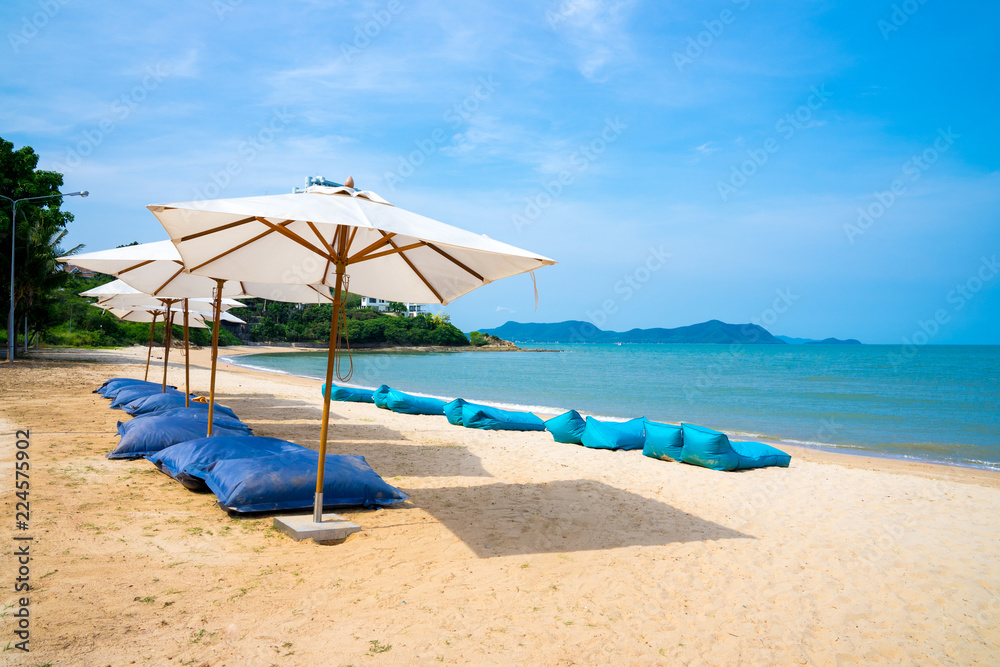 Blue chairs and Umbrella or tent  on beach lounge of hotel resort , Pattaya city, Chonburi,Thailand tropical countries.Vacation holidays background wallpaper concept