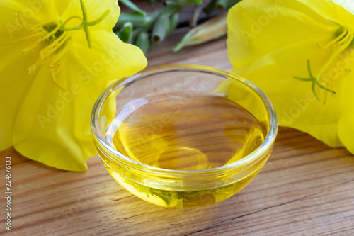 Evening primrose oil with fresh blooming evening primrose