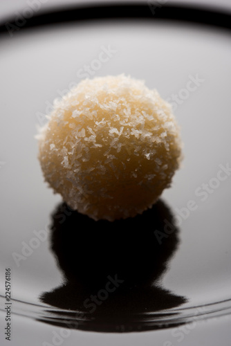 Coconut Sweet Laddoo OR Nariyal Ladduis a Popular Festival food from India. Served over moody background, selective focus photo