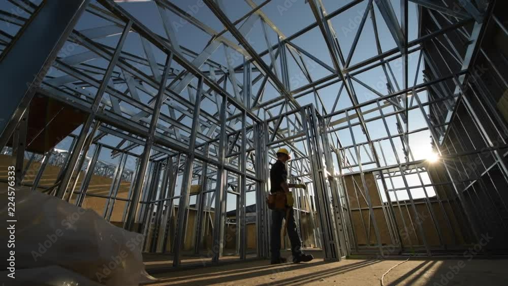 Steel Frame of the Building and Contractor Worker. The Construction Site.
