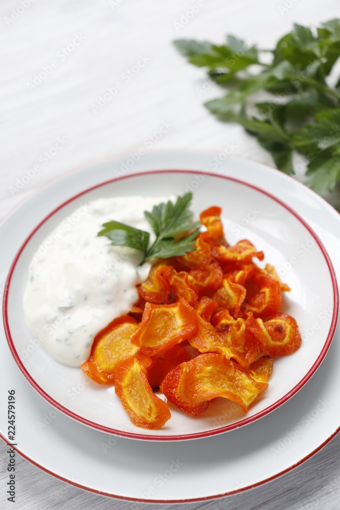 Carrot chips with sauce on a plate. Vertical. Carrot chips with sauce on a plate. Vertical.