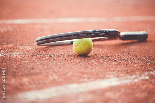 Close up of tennis racket with tennis ball © Khaligo