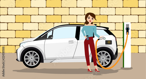 Woman charges an electric car at a charging station for electric vehicles.
