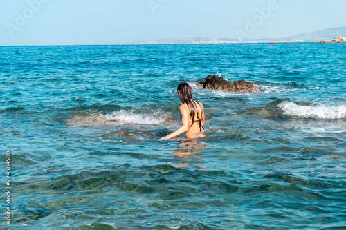 young woman having fun on sea waves