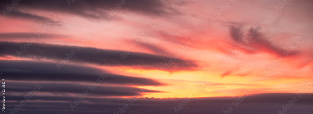 Dramatic orange and yellow sky with clouds background