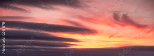 Dramatic orange and yellow sky with clouds background