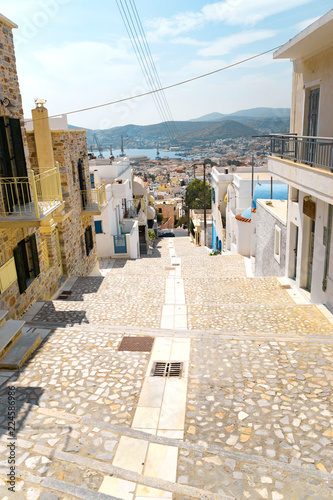 Fototapeta Naklejka Na Ścianę i Meble -  Сozy narrow streets of the old resort European town in a summer sunny day. Low-rise buildings of local residents, small cafes and hotels. Ermoupolis town on Syros island, Cyclades, greece.