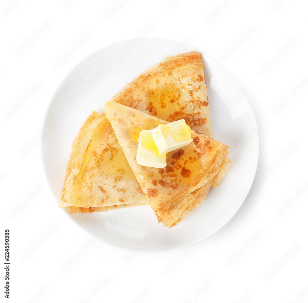 Tasty thin folded pancakes with butter and honey on plate against white background, top view
