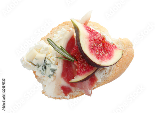 Sandwich with ripe fig, prosciutto and cream cheese on white background, top view
