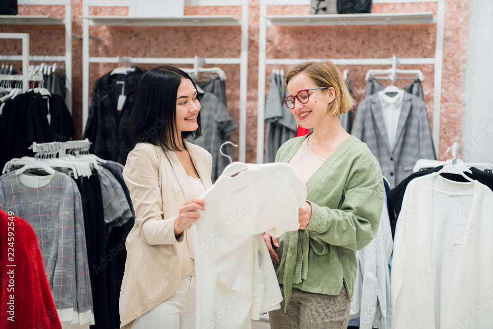 Obraz premium Fashion consultant showing clothes to the client