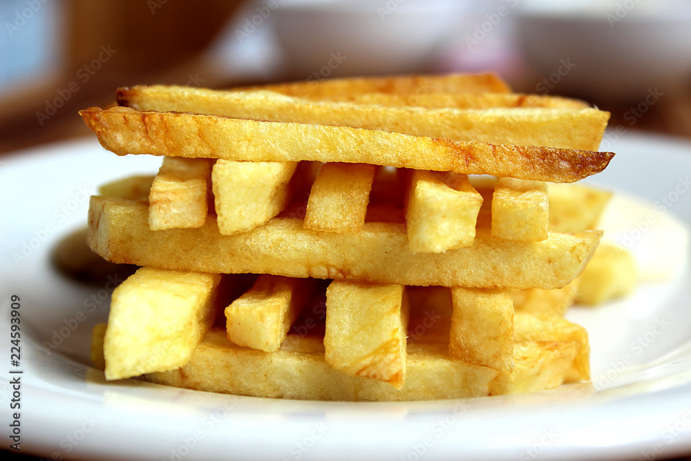 french fries on a cutting board with a cone french fries on a cutting board with a cone