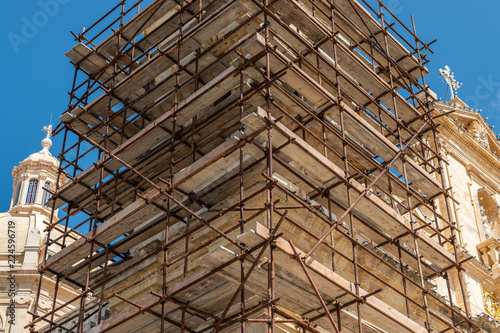 Construction scafold to restore church limestone.  Malta. horizontal.
