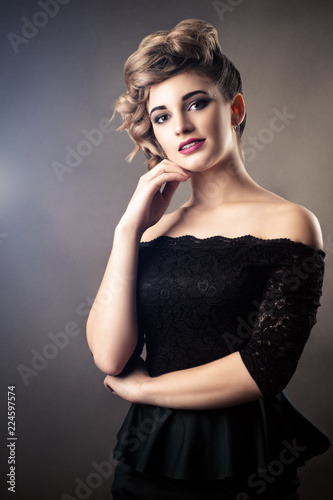 portrait charming woman in black dress with retro hairstyle