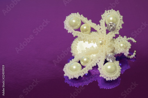 Brooch butterfly handmade from white beads, white artificial pearls and two zircons. Vew from above