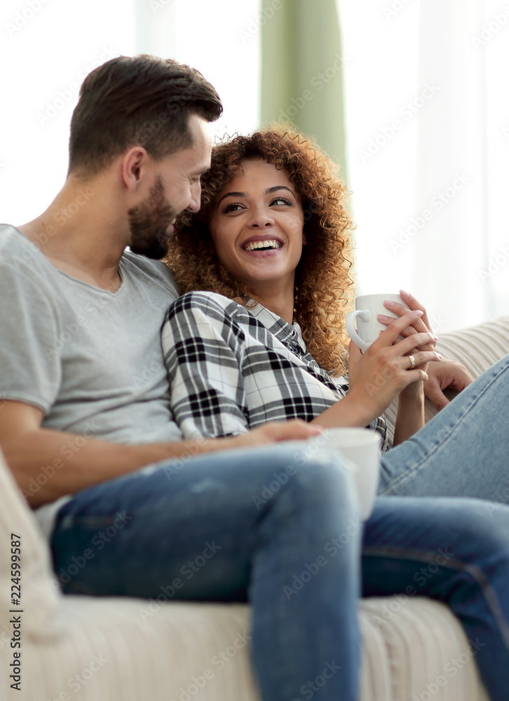 loving couple sitting on a sofa in the living room loving couple sitting on a sofa in the living room