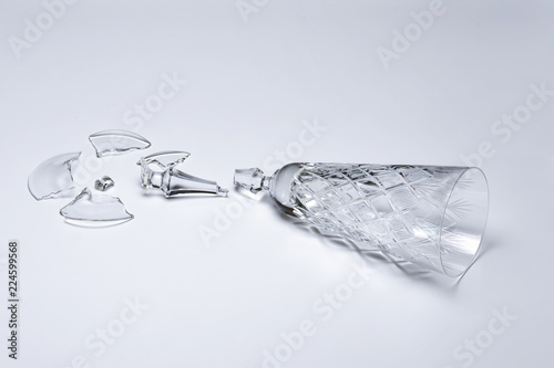 Broken crystal wine glass on white background © Makeev Petr