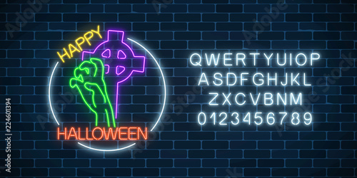Glowing neon sign of halloween banner with bony hand from grave and alphabet. Bright halloween night scary sign