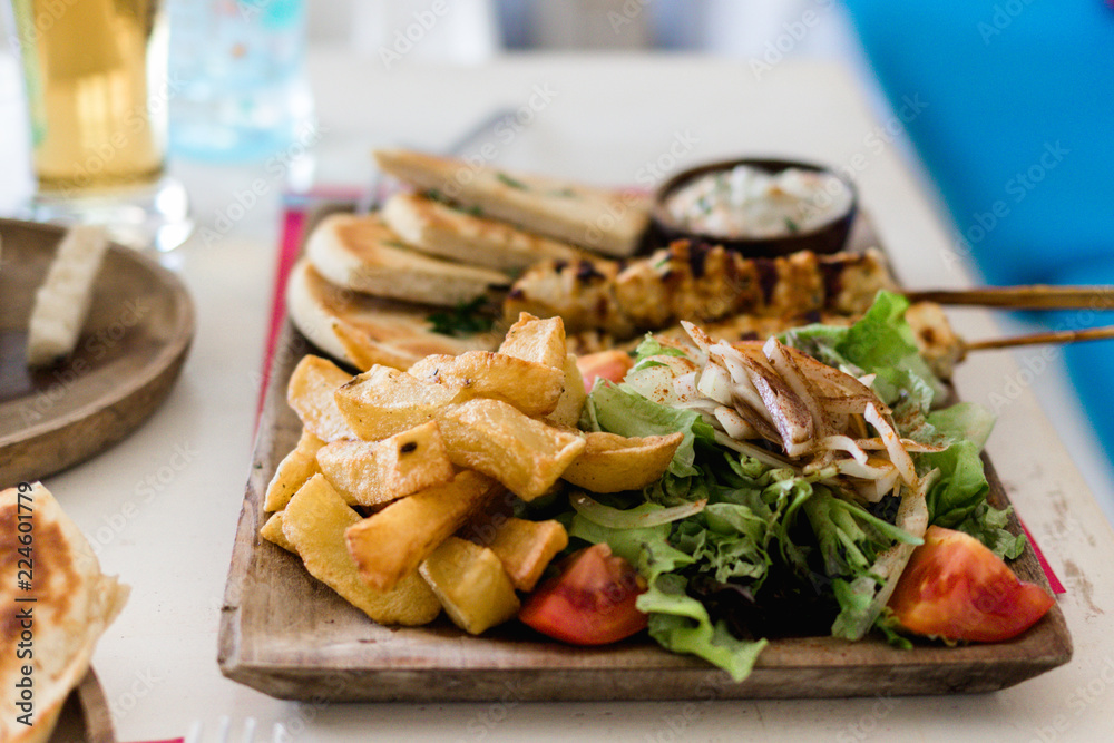 Greek gyros and souvlaki plate with pita bread and tzatziki Greek gyros and souvlaki plate with pita bread and tzatziki