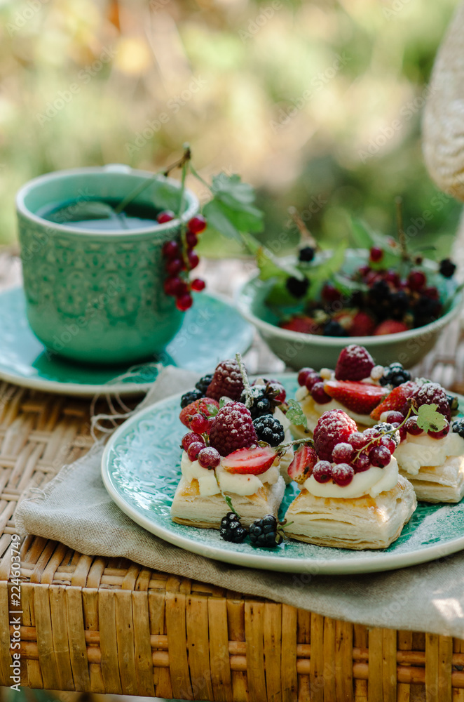 Puff pastry cakes with cream filling and berry topping