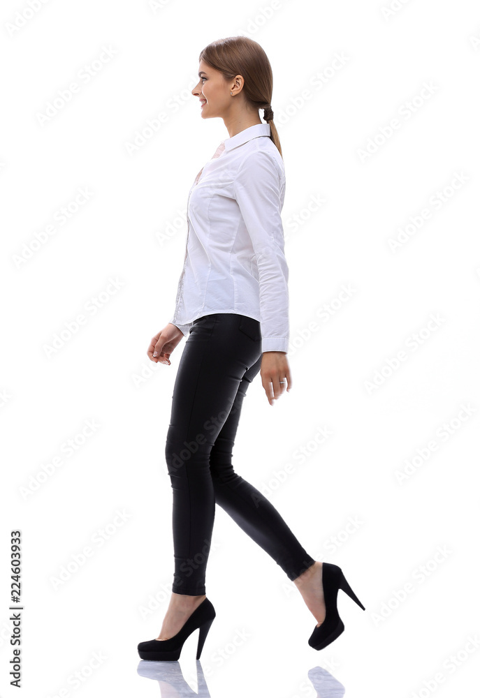 side view.in full growth.confident young woman is moving forward confidently. side view.in full growth.confident young woman is moving forward confidently.