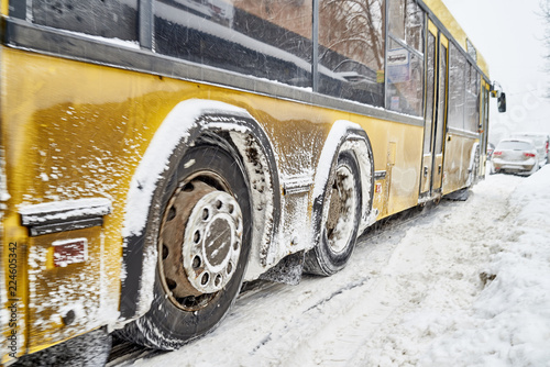 bus on a snow-covered road, snowfall is a problem element.