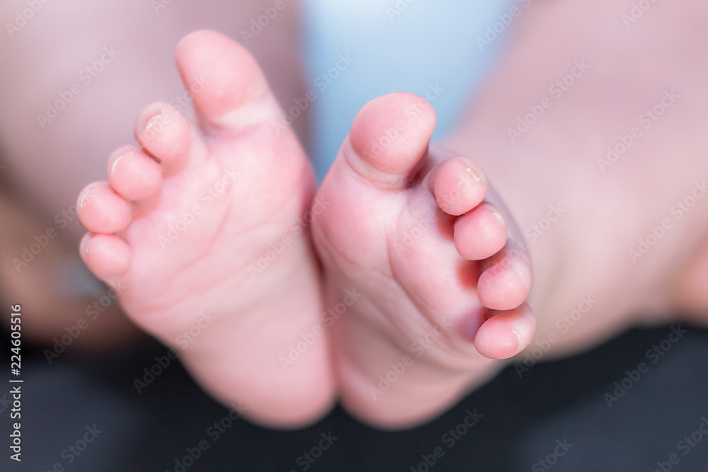 Newborn baby feet. Horizontal. Space for text. Background out of focus. Newborn baby feet. Horizontal. Space for text. Background out of focus.